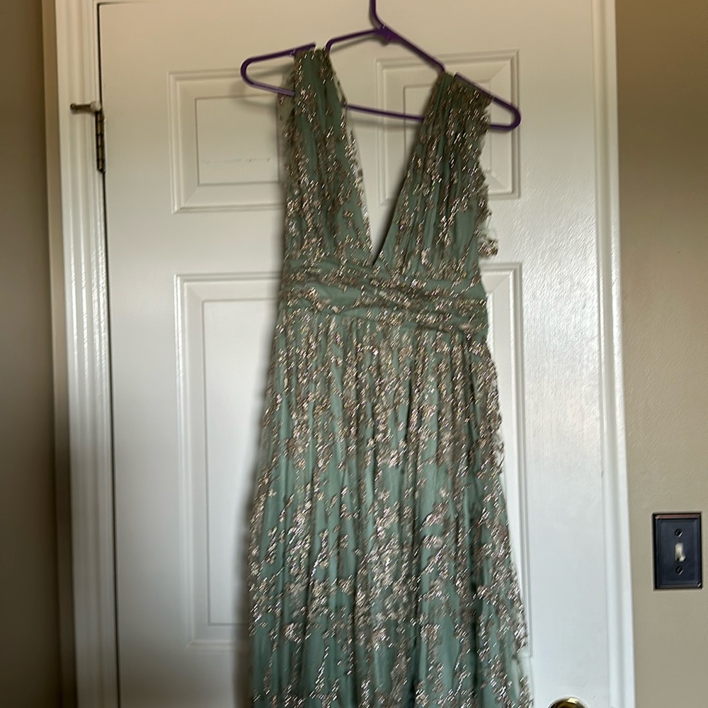 Beautiful low cut dress back and front with a slit